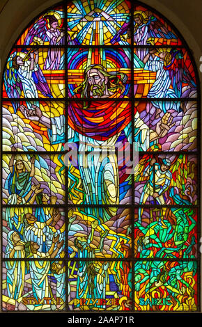 Stained-glass window depicting Jesus Christ in glory with the words 'from there He will come to judge' Roman Catholic Church of Saint Anne. Stock Photo