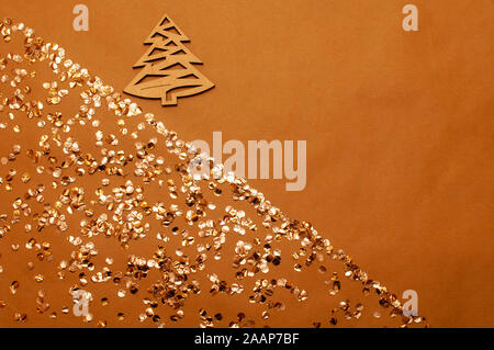 golden and silver shiny confetti lay against blue background Stock Photo