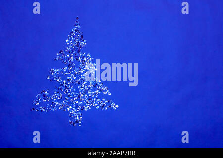 golden and silver shiny confetti lay against blue background Stock Photo
