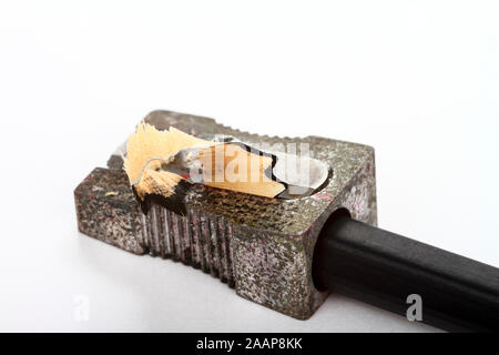 Wooden pencil in a metal sharpener isolated on a white background Stock Photo