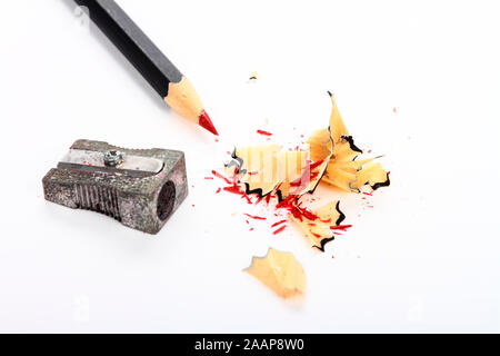 Red pencil and sharpener with shavings isolated on a white background Stock Photo