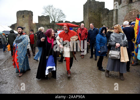 Ludlow, Shropshire, UK. 23rd November 2019. Ludlow Medieval Christmas Fayre 23rd November 2019 held in the grounds of ancient castle. Jester dancing in the mud. Credit: David Bagnall/Alamy Live News Stock Photo