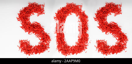 word sos from shredded paper concept of economical use of resources, recycling, separate garbage collection. Eco-friendly concept. on white background Stock Photo