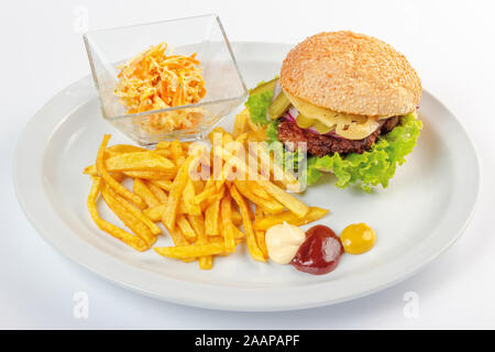 fast food menu. hamburger, french fries and salad. burger with beef stake, cheese onion and pickle. mayonnaise ketchup mustard on the white plate. hea Stock Photo