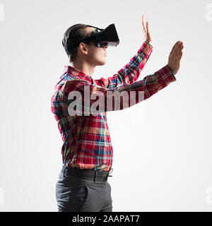 Guy in mask experiencing virtual reality as new entertainment device Stock Photo