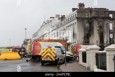 Eastbourne, UK. 23rd November, 2019.  East Sussex Fire and Rescue Service remain at the scene of yesterdays devastating fire which gutted  the Claremont Hotel, Eastbourne. The seafront including the towns famous pier, itself severely damaged by fire in 2014 remain closed to traffic and pedestrians whilst the clearing up operation continues. Credit: Alan Fraser/Alamy Live News Stock Photo