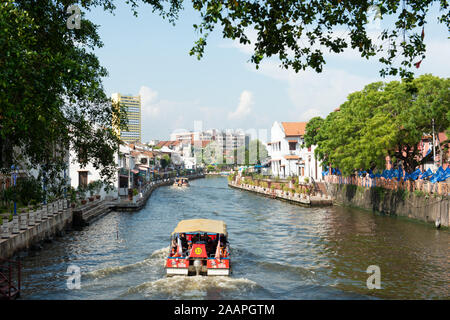 A boat sailing sown the river in Malacca, Malaysia Stock Photo