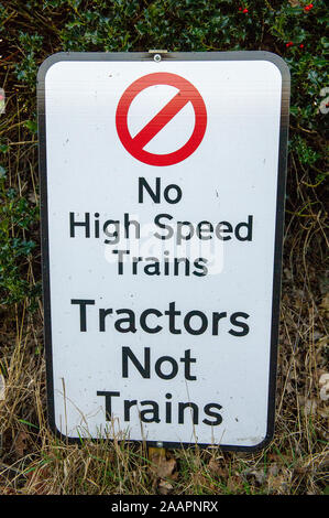 Tractors Not Trains HS2 opposition sign on A413 near Great Missenden in Buckinghamshire, UK. 1st February, 2012. A number of High Speed Railway HS2 opposition signs have been placed in fields and on buildings in the county of Buckinghamshire. Many local residents are opposed to the planned HS2 High Speed Rail link from London to Birmingham as it is expected to result in the destruction of countryside, rural habitats and ancient woodlands. Credit: Maureen McLean/Alamy Stock Photo
