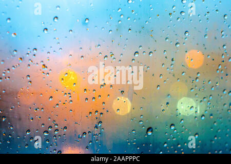 Closeup on waterdrops in glass with colorful bokeh on the background Stock Photo
