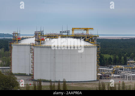 Large industrial tanks for petrochemical plant, oil and gas fuel or water in refinery or power plant for industrial plant on blue sky background. Stock Photo