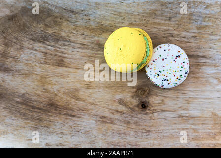 French delicious dessert macaroons on table On a wooden background. Stock Photo