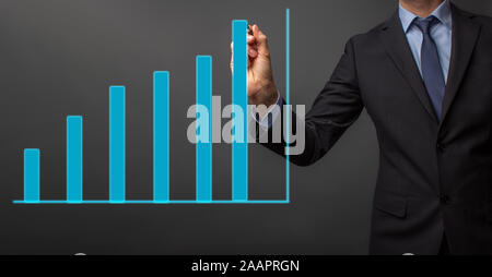 business man in suit is drawing a growth rate - anual growth rate - business decrease or inrease Stock Photo