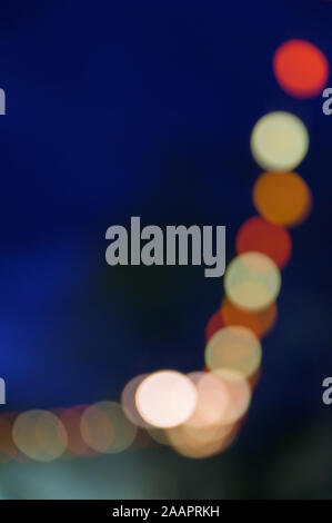 Multi-colored bokeh balls against a dark background Stock Photo