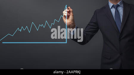 business man in suit is drawing a growth rate - anual growth rate - business decrease or inrease Stock Photo