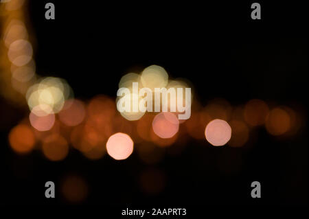 Multi-colored bokeh balls against a dark background Stock Photo