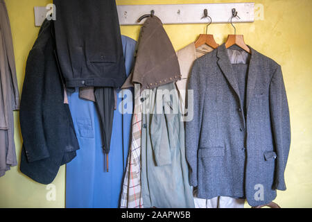 Coats hanging on a wall inside James heriots home, World of James Herriot , Thirsk , Yorkshire UK Stock Photo