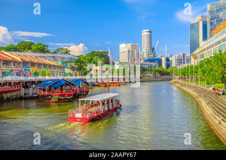 Singapore - May 5, 2018: bridge prospective view of Clarke Quay and Riverside area in Singapore, Southeast Asia. Waterfront skyline with cruise boat Stock Photo