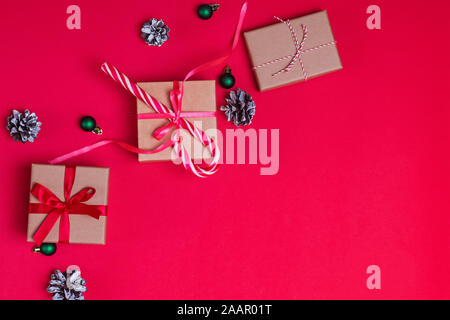 Gift boxes tied with ribbons with bows on red background, top view Stock Photo