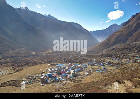 view of the small town of kyanjin gompa in a valley surrounded by mountains Stock Photo
