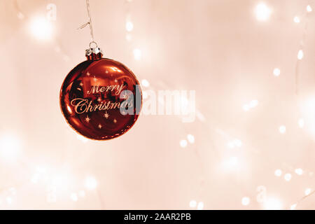 A 'Merry Christmas' Decoration with lights in the background Stock Photo