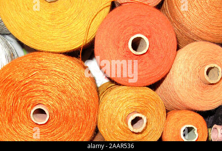 close-up, background, large group of fine cotton and linen yarn in yellow tones on large spools for my web project, arts and crafts area Stock Photo