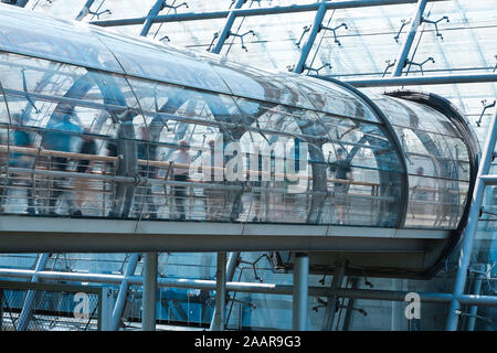 Business people walking through elevated walkway Stock Photo
