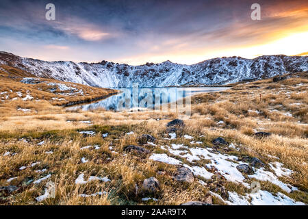 Beautiful colorful sunrise with view on snowy mountain range reflected in Angelus Lakes near Angelus Hut in Nelson Lakes National Park, New Zealand Stock Photo