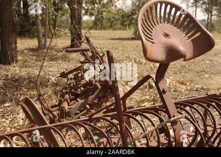 Very old rusted farming equipment like agricultural field cultivator from the turn of the century Stock Photo