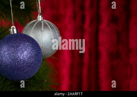 Blue and white baubles in front of red background, photo-illustration Stock Photo