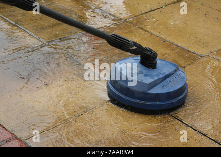 Cleaning patio paving slabs with pressure washer Stock Photo