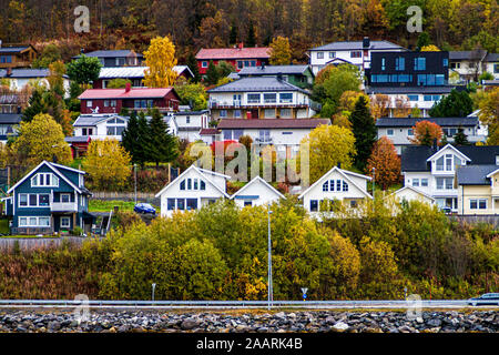 Norwegian town near a fjord with a forest behind Stock Photo