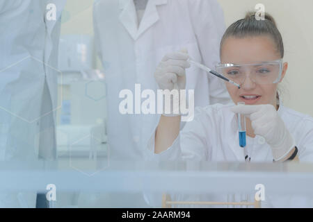 Young female scientist doing experiments in laboratory Stock Photo