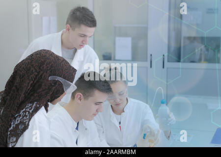Group of young  scientists doing experiments in laboratory Stock Photo