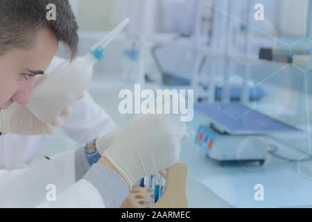 Young male scientist doing experiments in laboratory Stock Photo