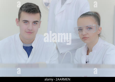 Group of young  scientists doing experiments in laboratory Stock Photo