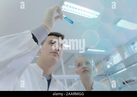Two young students scientists doing experiments in laboratory Stock Photo