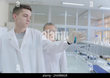 Two young students scientists doing experiments in laboratory Stock Photo