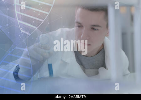 Young male scientist doing experiments in laboratory Stock Photo