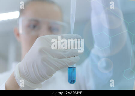 Young female scientist doing experiments in laboratory Stock Photo
