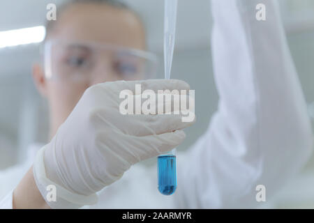 Young female scientist doing experiments in laboratory Stock Photo