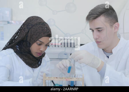 Two  young student scientists doing experiments in laboratory Stock Photo