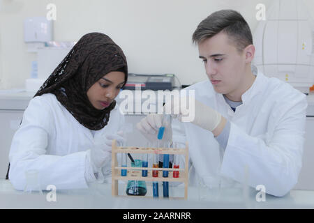 Two  young student scientists doing experiments in laboratory Stock Photo
