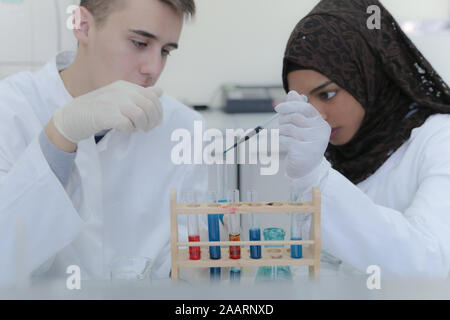 Two  young student scientists doing experiments in laboratory Stock Photo