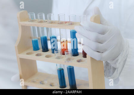 Female Research Scientist Uses Micropipette Filling Test Tubes in a Big Modern Laboratory. Stock Photo