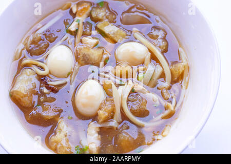 Braised fish maw in red gravy in bowl on white background. Stock Photo