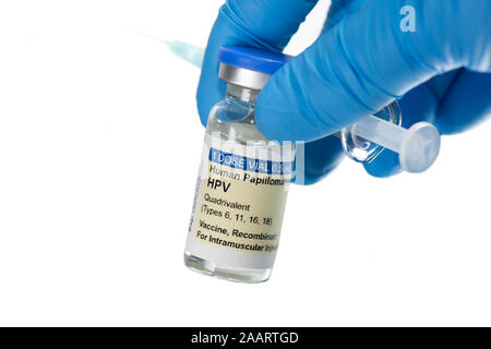 Gloved hand holding Human Papilloma Virus vaccine HPV with syringe isolated on white. Stock Photo