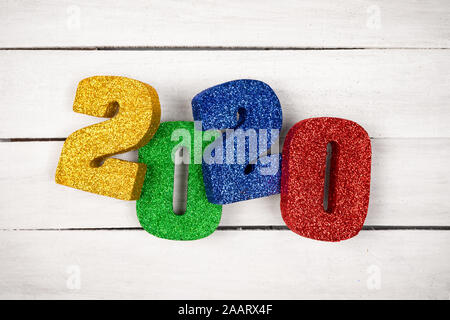 Glitter 3D numbers 2020 on plain white wooden table - new years concept graphic resource image with copy space for text Stock Photo