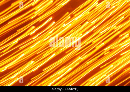 Futuristic blurred lights holiday monochrome background in yellow. Horizontal, soft focus Stock Photo