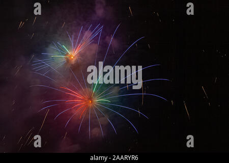 Beautiful and brilliant blue, red and green fireworks lighting up the sky Stock Photo