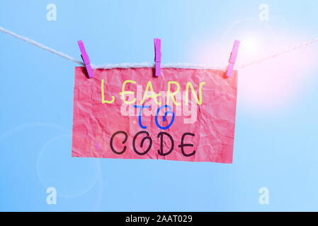 Handwriting text writing Learn To Code. Conceptual photo Learn to write Software Be a Computer Programmer Coder Clothesline clothespin rectangle shape Stock Photo